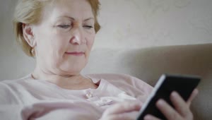 Free Stock Video Senior Woman Looking At Reading Device Live Wallpaper