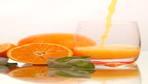 Free Stock Video Serving Juice In A Glass With Some Oranges On A Live Wallpaper