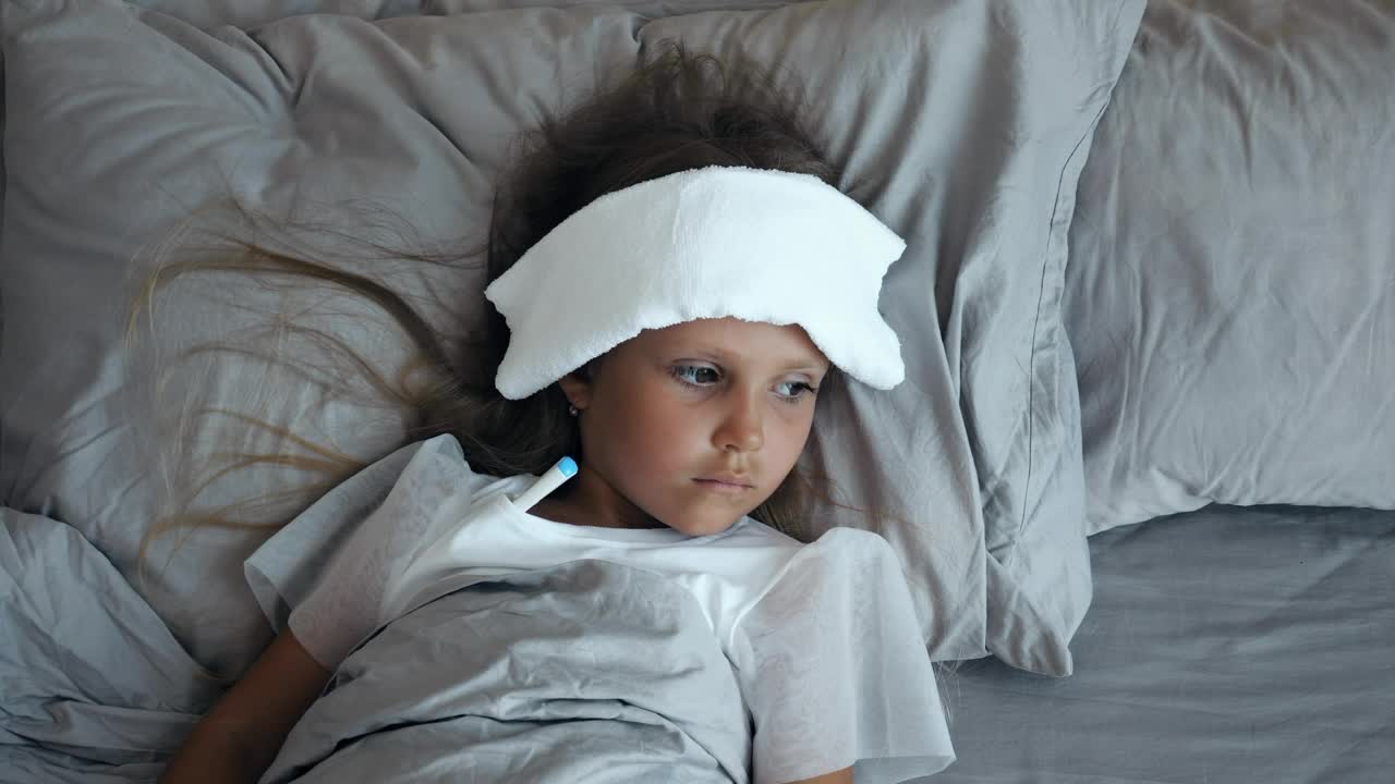 Download Free Stock Video Sick Child With A Thermometer And A Compress Live Wallpaper