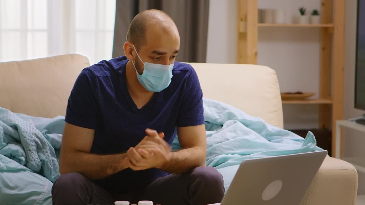 Download Free Stock Video Sick Man Chats On Video Call From Couch At Home Live Wallpaper