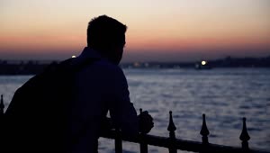 Free Stock Video Silhouette Of A Lonely Man At Dusk Near A River Live Wallpaper
