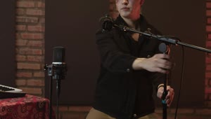 Free Stock Video Singer Arranging Her Microphones In A Recording Studio Live Wallpaper