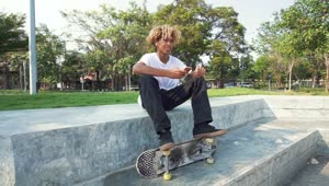 Free Video Stock Skater Sitting In A Park Listening To Music Live Wallpaper