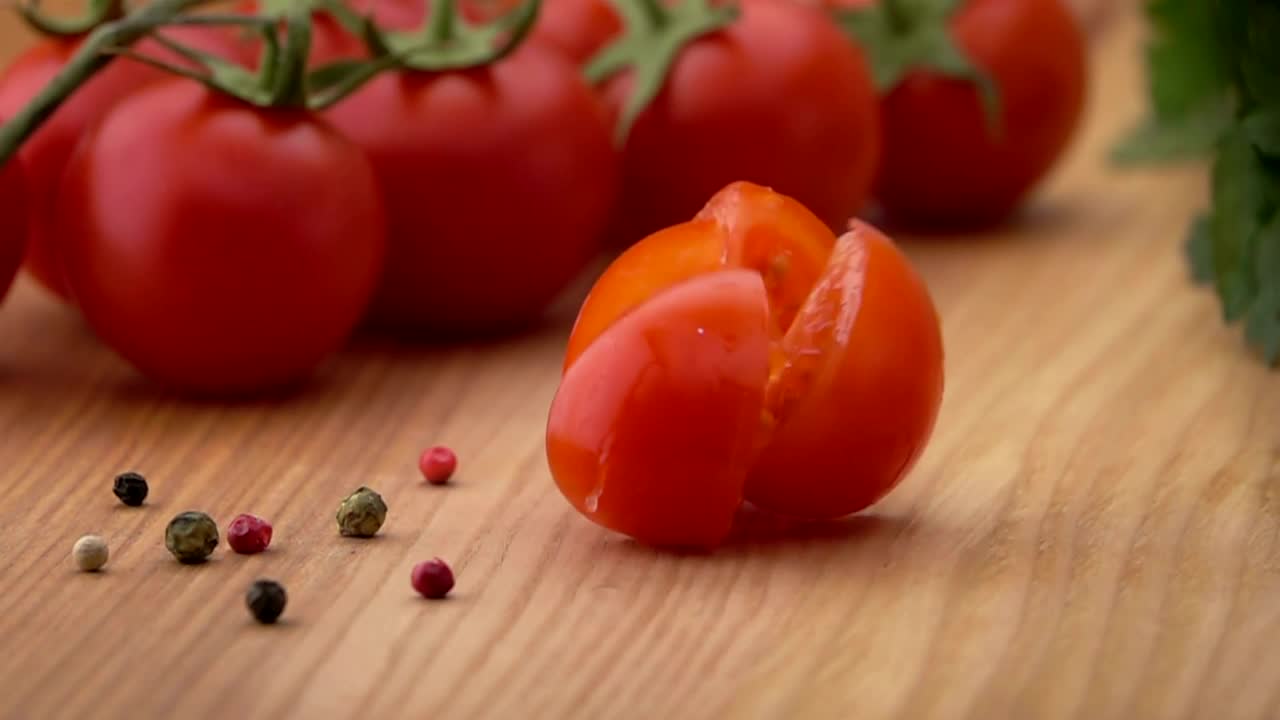Download Free Video Stock Sliced Tomato Falls On A Wooden Board Live Wallpaper