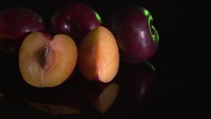 Free Video Stock Sliced Plums Against A Dark Background Live Wallpaper