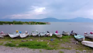 Free Video Stock Small Boats On The Shore Of A Huge Lake Live Wallpaper