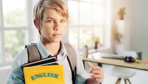 Free Video Stock Smiling Boy Holds English Education Book In Bright Room Live Wallpaper