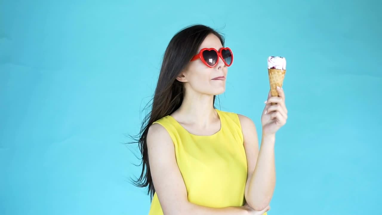 Download Free Video Stock Smiling Model Holding Ice Cream On Blue Background Live Wallpaper