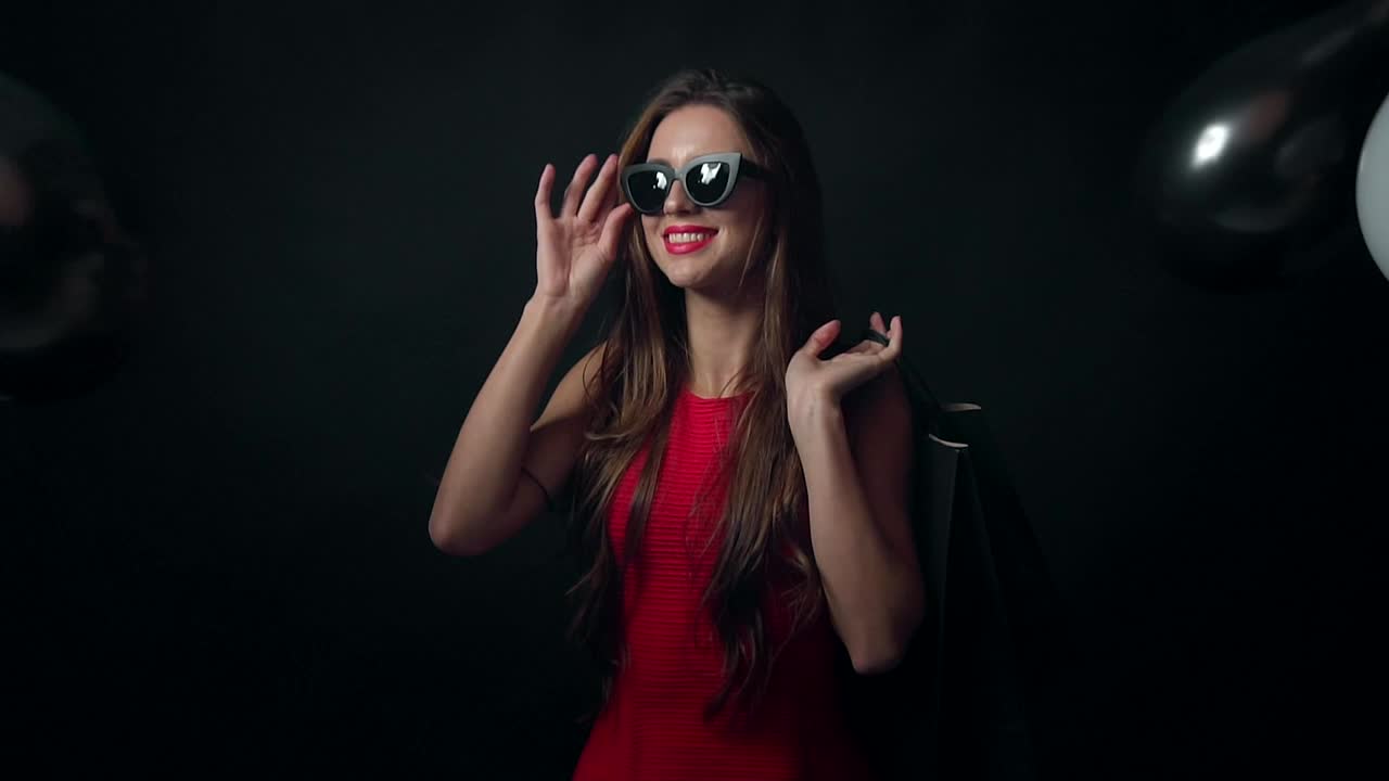 Download Free Video Stock Smiling Model With Falling Balloons On Black Background Live Wallpaper