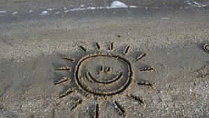 Free Video Stock Smiling Sun Drawn In The Sand On A Beach Live Wallpaper