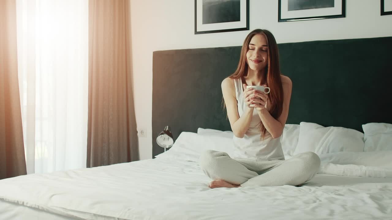 Download Free Video Stock Smiling Woman Enjoying Morning Coffee In Bed Live Wallpaper