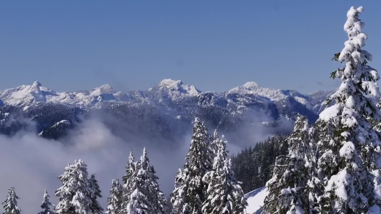 Download Free Video Stock Snowy Mountain Range Seen Above The Clouds Live Wallpaper