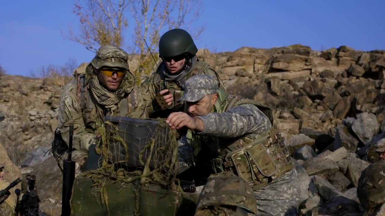 Download Free Video Stock Soldiers Looking At Computer Outdoors Live Wallpaper