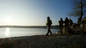 Free Video Stock Soldiers Walking By The Lake At Sunset Live Wallpaper