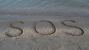 Free Video Stock Sos Written In The Sand On The Shore Of A Live Wallpaper