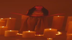 Free Video Stock Spiritual Girl Meditating Among Many Burning Candles Live Wallpaper