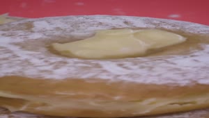 Free Video Stock Spreading Icing Sugar On A Donut With Custard Live Wallpaper