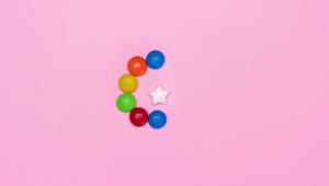 Free Video Stock Star Candy Surrounded By Chocolates On A Pink Background Live Wallpaper