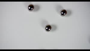 Free Video Stock Steel Pellets Rolling On White Surface Live Wallpaper