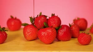 Free Video Stock Strawberries Are Covered In Chocolate On A Pink Background Live Wallpaper