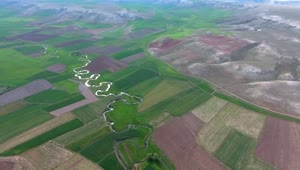 Free Video Stock Stream Between Sgricultural Fields In A Wide Valley Live Wallpaper