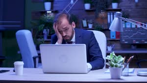 Free Video Stock Stressed Businessman Rubs Eyes While Working On Laptop Live Wallpaper