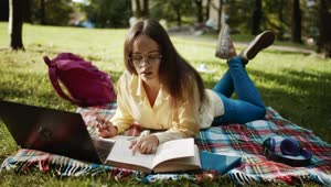 Free Video Stock Student Learning In Park With Laptop And Book Live Wallpaper
