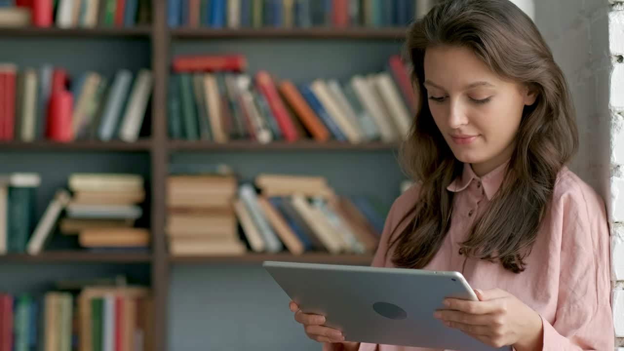 Download Free Video Stock Student Reading On A Tablet At A Library Live Wallpaper