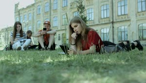 Free Video Stock Students Resting On The Grass At A University Live Wallpaper