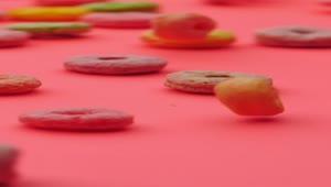 Free Video Stock Sugar Ring Cereal Gliding Across A Pink Surface Live Wallpaper