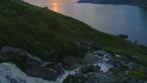 Free Video Stock sunset flyover waterfall and sea coast in norway Live Wallpaper