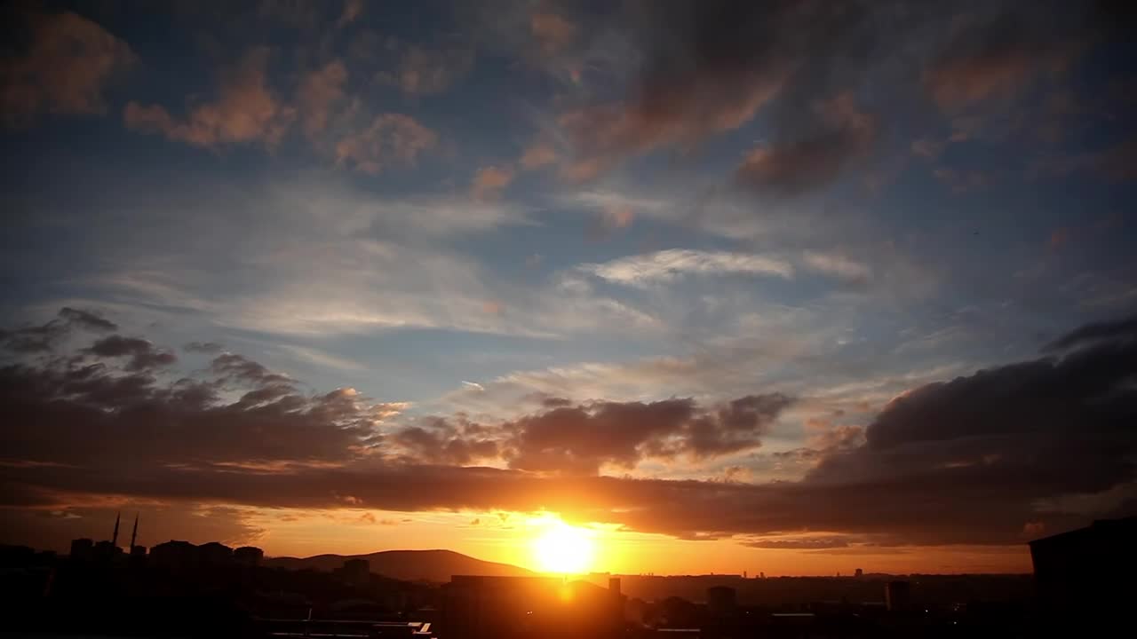 Download Free Video Stock sunset from a city and clouds traveling in the sky Live Wallpaper