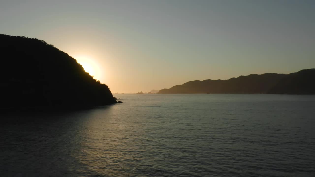 Download Free Video Stock sunset seen at sea from a coast aerial shot Live Wallpaper
