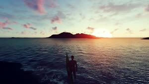 Free Video Stock surfer looking at an island at sunset Live Wallpaper