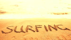 Free Video Stock surfing written in the sand on a sunny beach Live Wallpaper