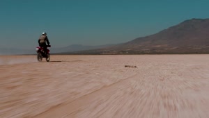 Free Video Stock tacking view of a motorcyclist in the desert Live Wallpaper