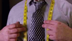 Free Video Stock tailor tying up a measuring tape Live Wallpaper