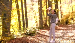 Free Video Stock taking photos with her cell phone of autumn nature Live Wallpaper