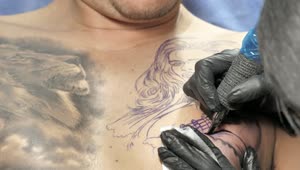 Free Video Stock tattooist tattooing on a mans chest Live Wallpaper