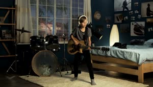 Free Video Stock teen boy playing guitar in his bedroom Live Wallpaper