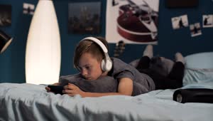 Free Video Stock teen boy playing on his phone on the bed Live Wallpaper