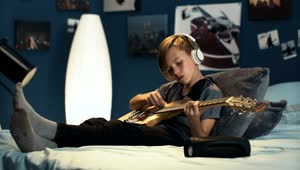Free Video Stock teen boy practicing guitar on his bedroom Live Wallpaper