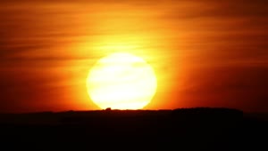Free Video Stock the sun hiding on the horizon during sunset Live Wallpaper