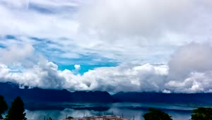 Free Video Stock thick clouds above a still lake Live Wallpaper
