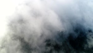 Free Video Stock thick clouds over a mountain Live Wallpaper
