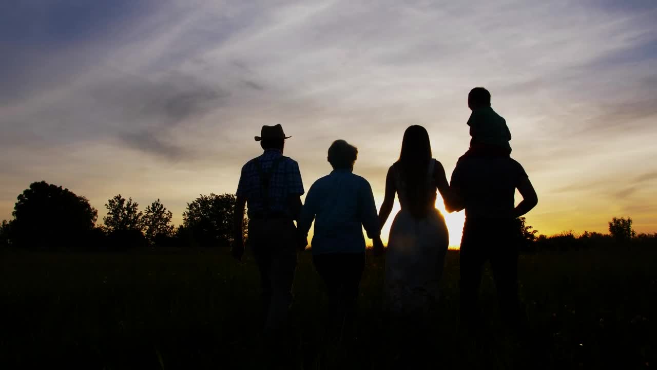 Download Free Video Stock three generations walking together at sunset Live Wallpaper