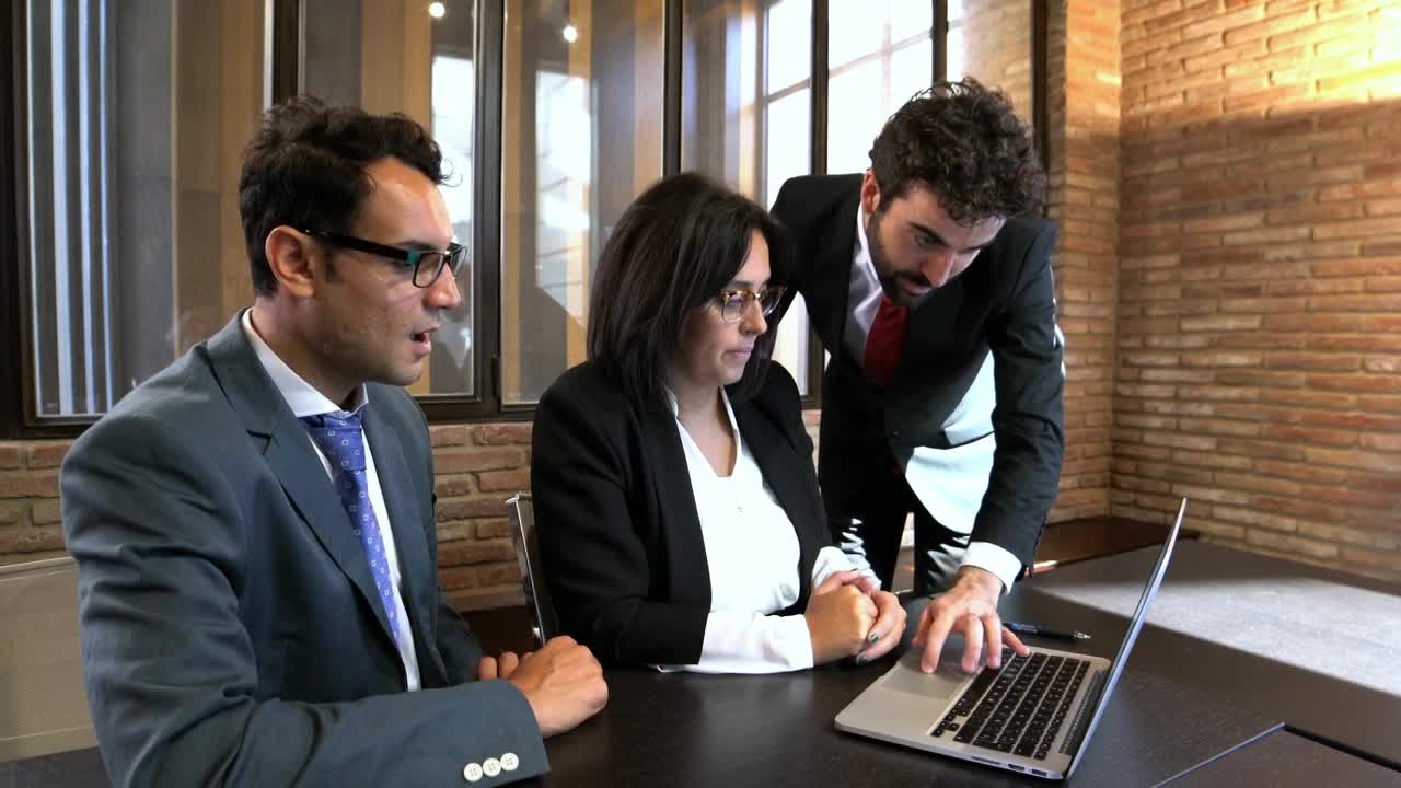 Download Free Video Stock three office colleagues working together Live Wallpaper