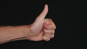 Free Video Stock thumbs up against a dark background Live Wallpaper