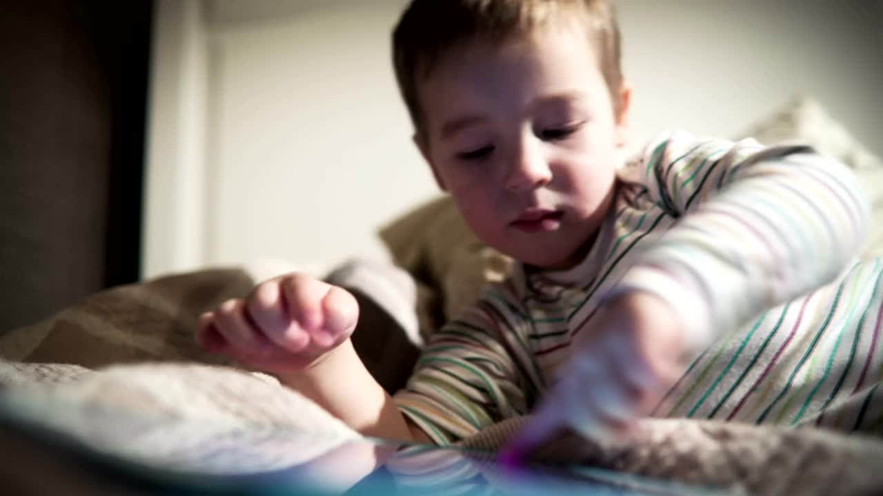 Download Free Video Stock tired boy using a tablet Live Wallpaper