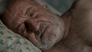 Free Video Stock tired old man wakes up in his bed Live Wallpaper